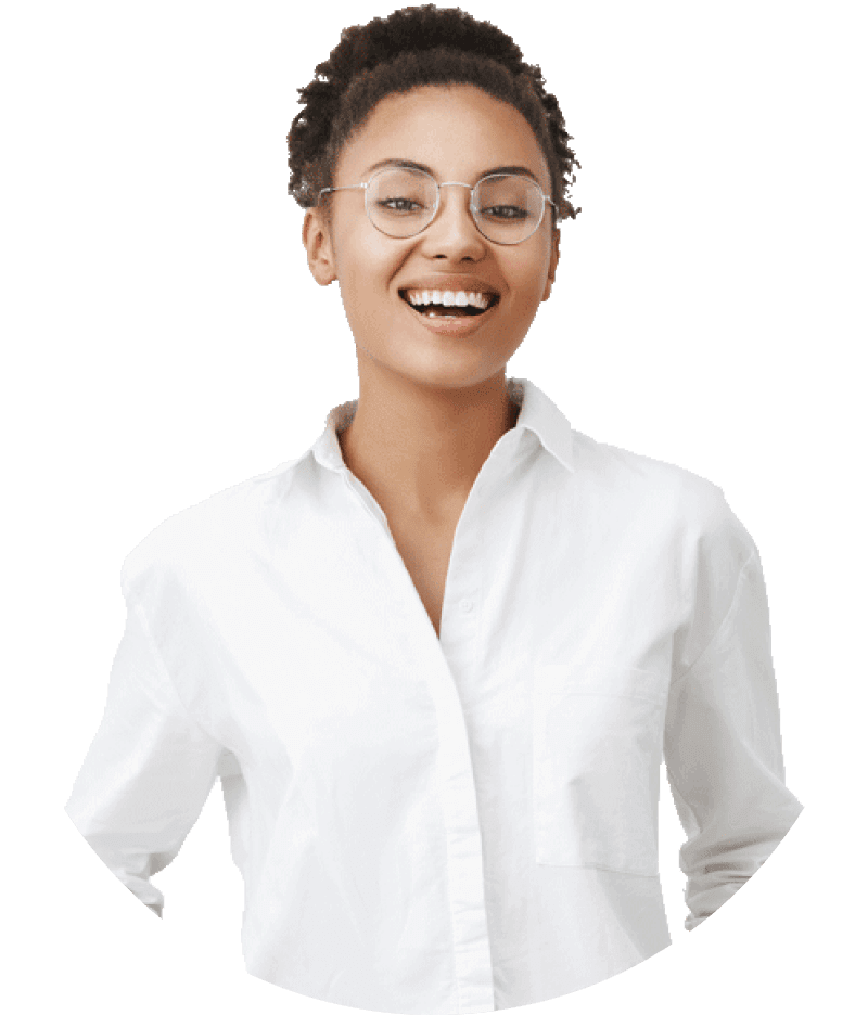 Smiling person with short curly hair and glasses wearing a white shirt against a light background.