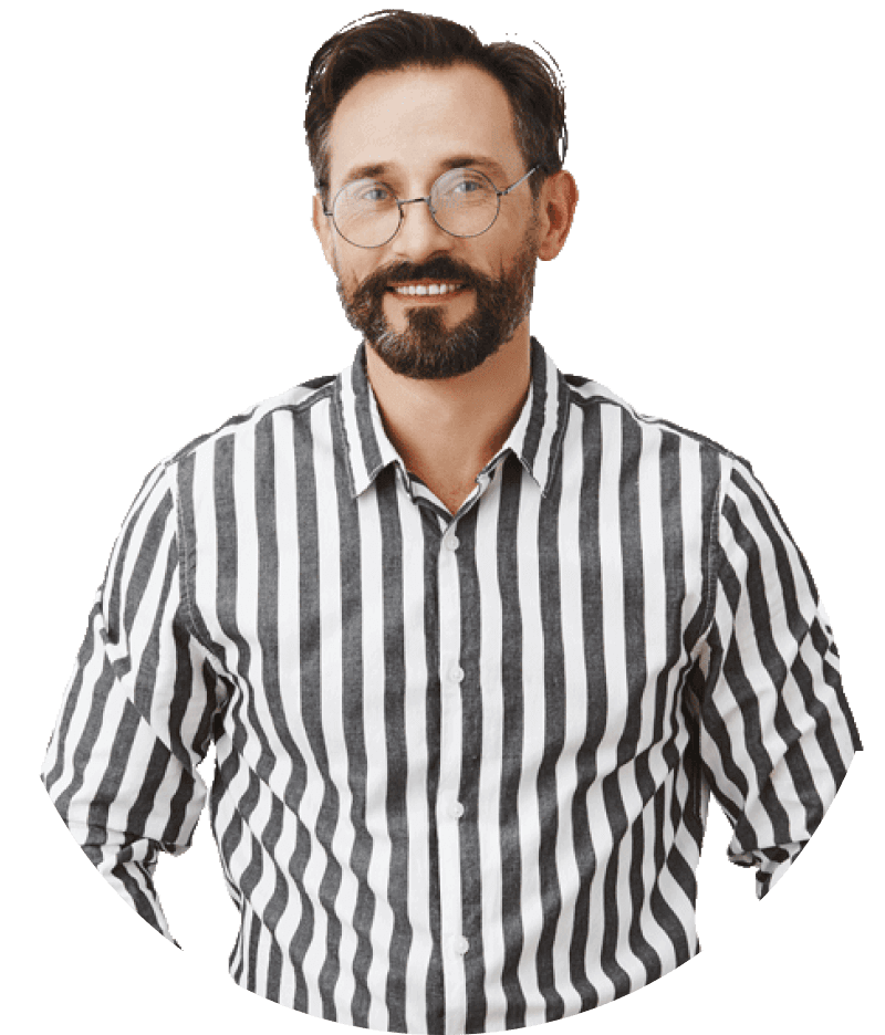 Man with glasses and a beard wearing a black-and-white striped shirt, smiling at the camera.