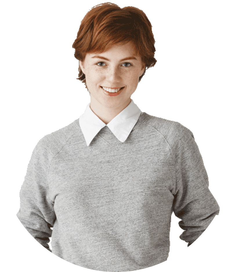 Young woman with short red hair, wearing a gray sweater over a white collared shirt, smiling at the camera.