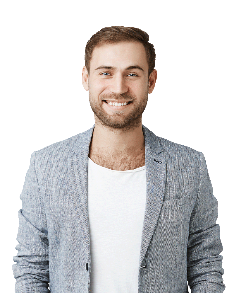 Smiling man in a light gray blazer and white shirt standing against a plain white background.