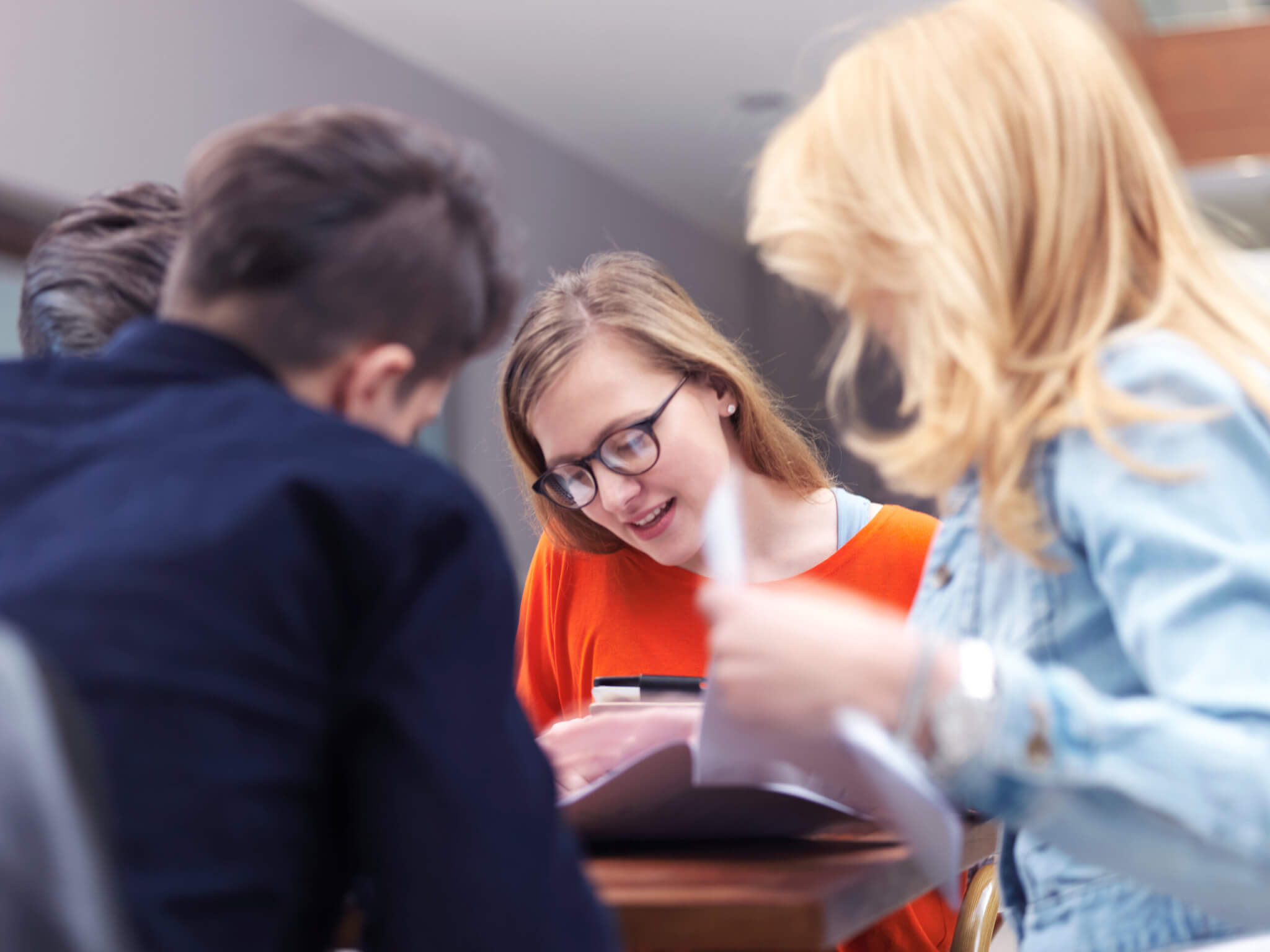 students group working on school  project  together on tablet computer  at modern university